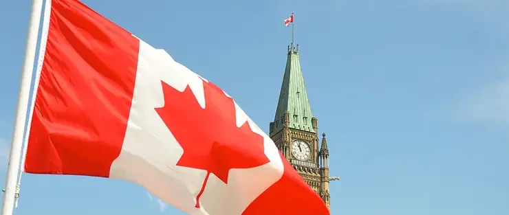 Canadian flag with parliament tower