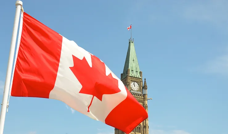 Canadian flag with parliament tower