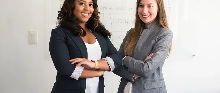 Two businesswomen smiling confidently