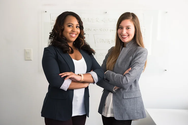 Two businesswomen smiling confidently